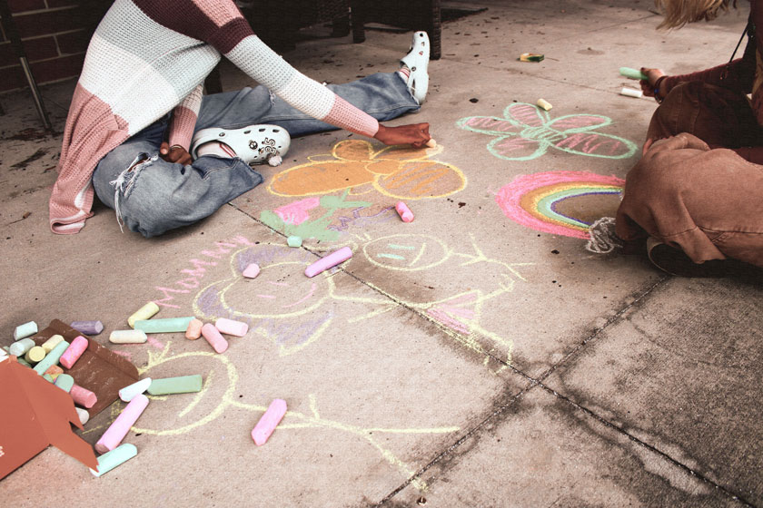 Photo of chalk and aartists on sidewalk