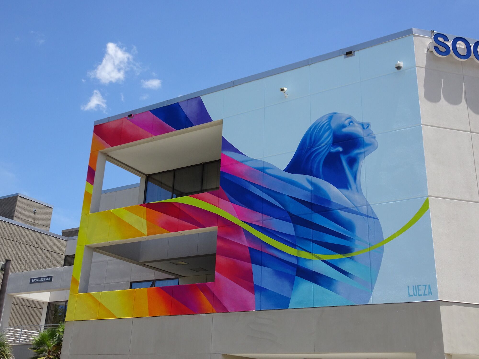 Colorful mural of a woman with arms lifted