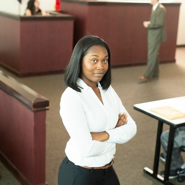 Paralegal student posing in front of courtroom