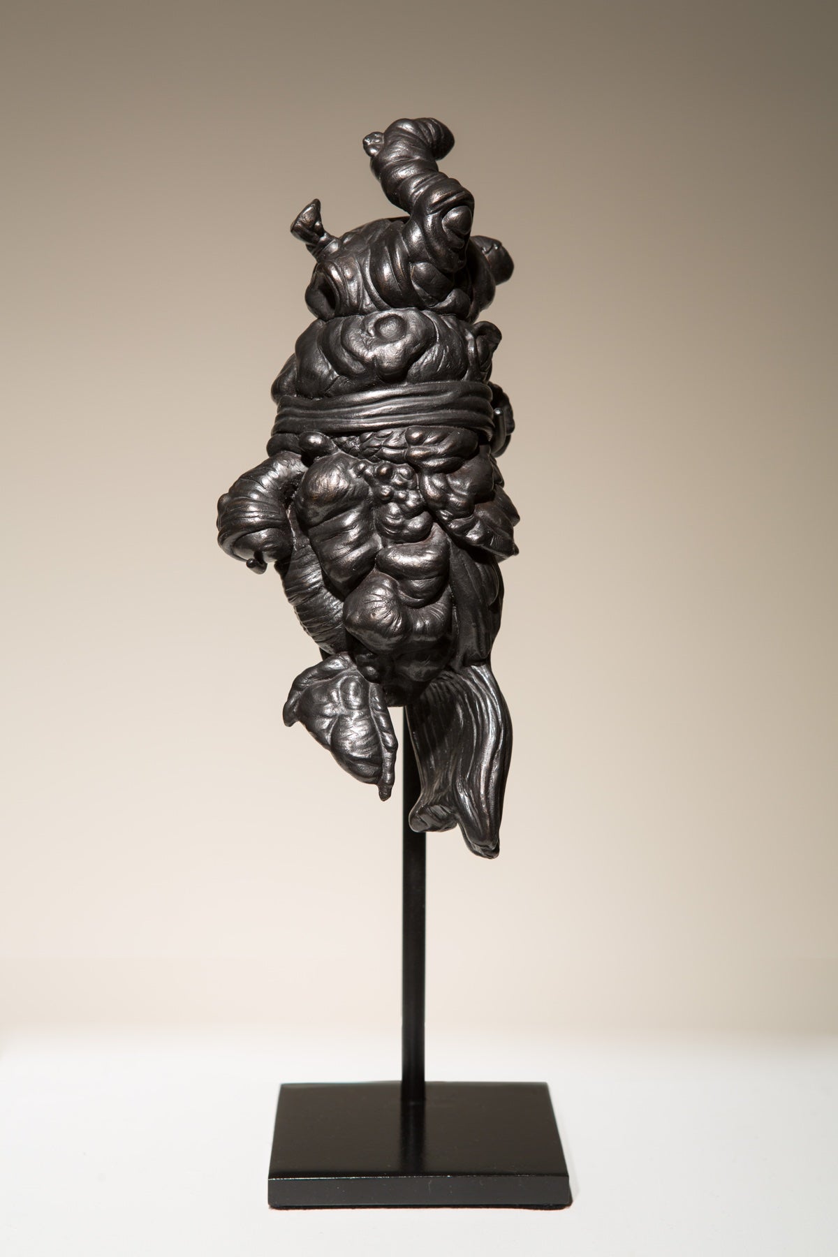 Organic sculpture mounted on rod pedestal