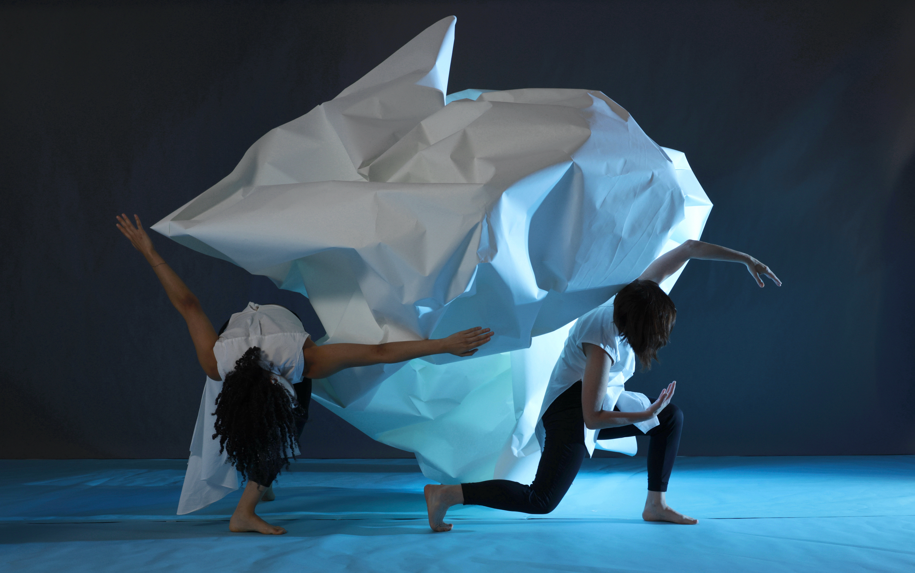 Dancers dancing with glacier-looking sheet
