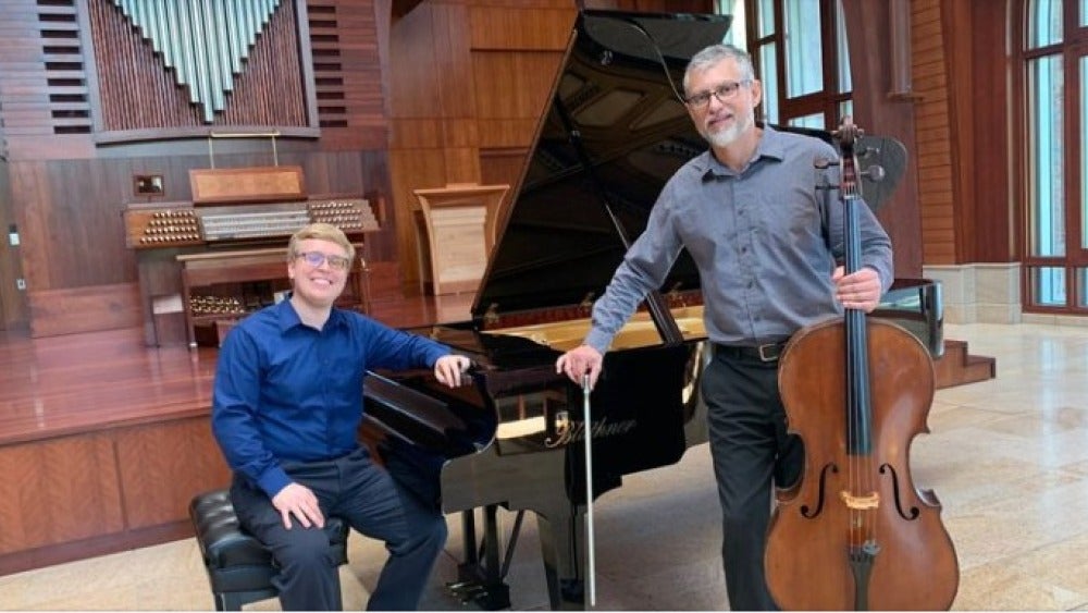 A pianist and cellist smiling