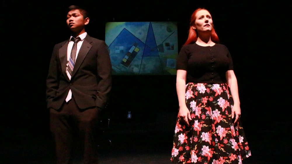 Two student actors on stage facing the audience