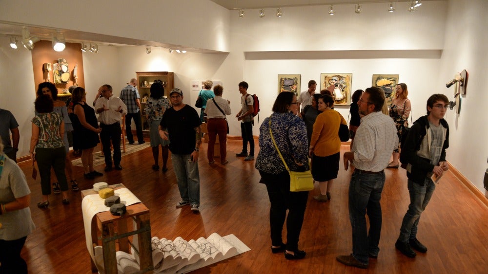 Group of people inside Ybor City art gallery