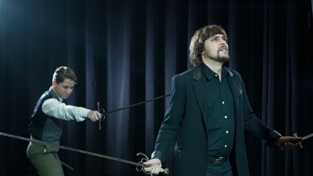 Student actors in staged sword fight