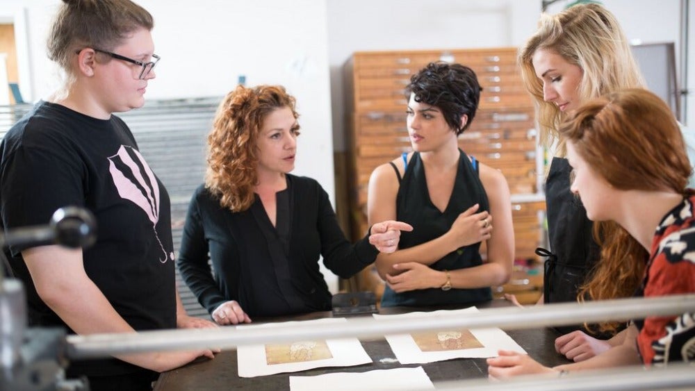 Instructor talking with students