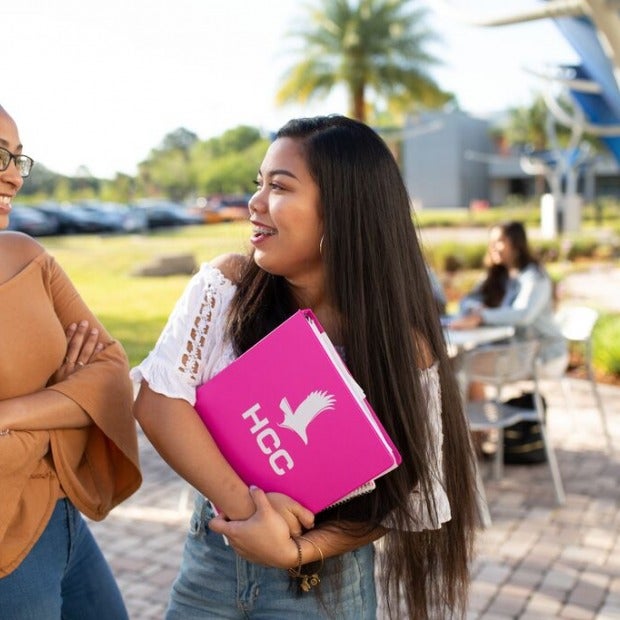 Students talking outside on campus.