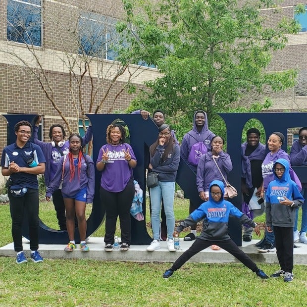 A group of students standing on a lawn