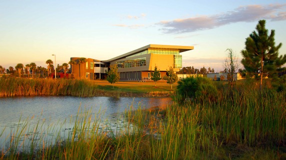 evening environmental shot showing the exterior of the SouthShore campus next to a lake