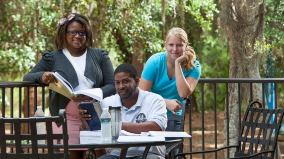 group of students in an outside patio studying