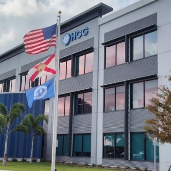 Three story building with flags in front