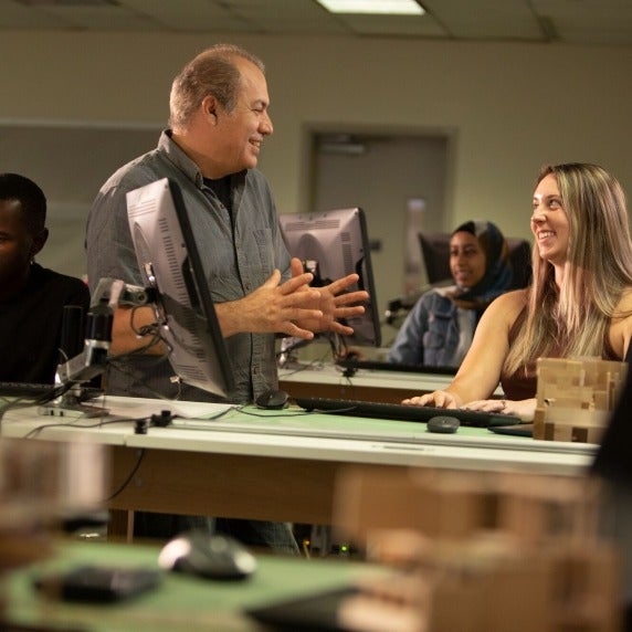 Faculty member talking to student