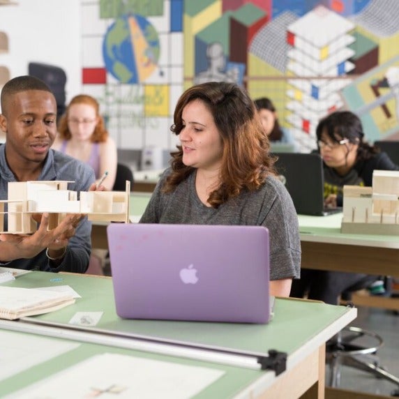 Two students examining a class project 