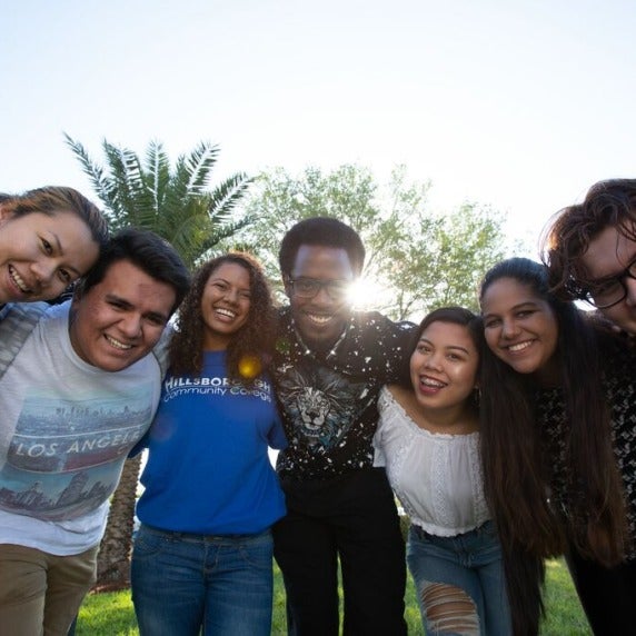 HCC students smiling with arms linked