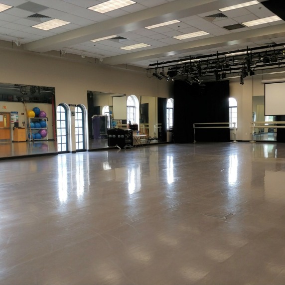 Open dance space with screen for watching videos