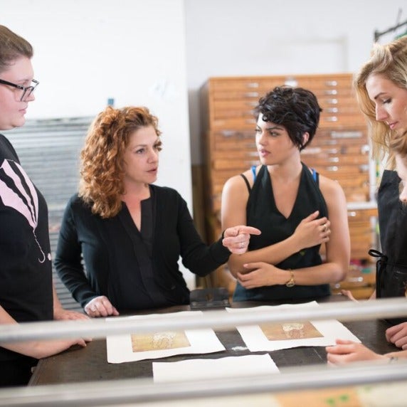 Instructor talking with students