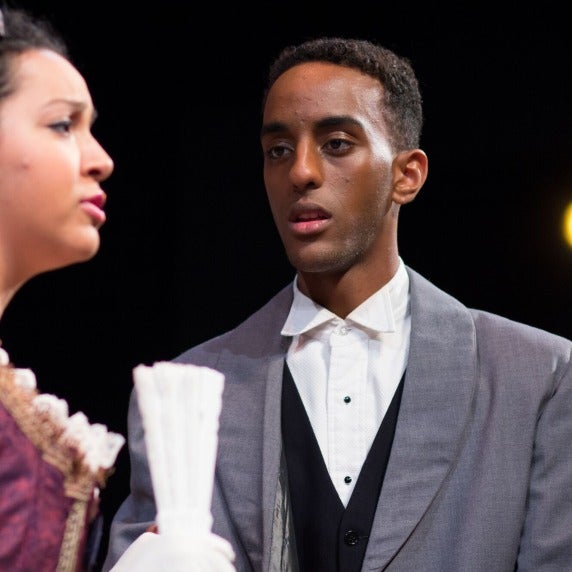 Closeup of man and woman speaking.