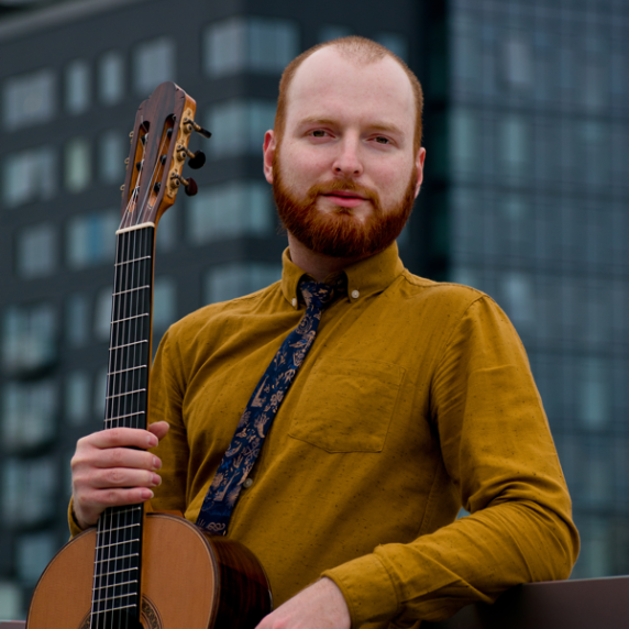 Photo of Marko Topchii holding guitar
