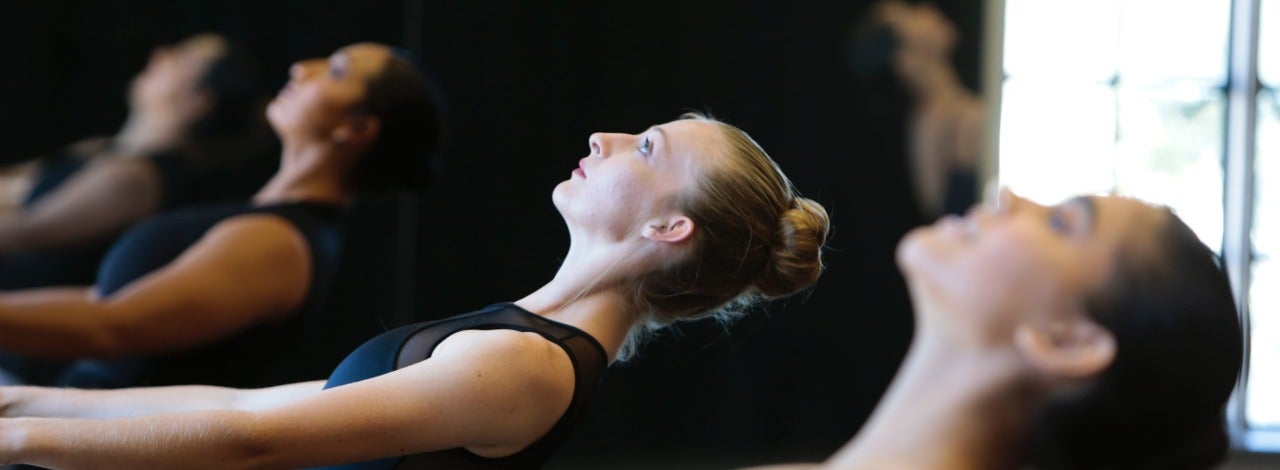 Several dancers looking upwards