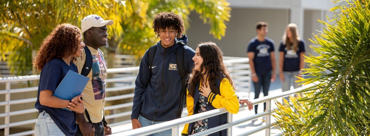 Four students talking on bridge