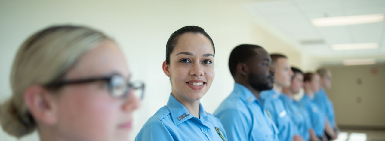 Female police academy student smiling .