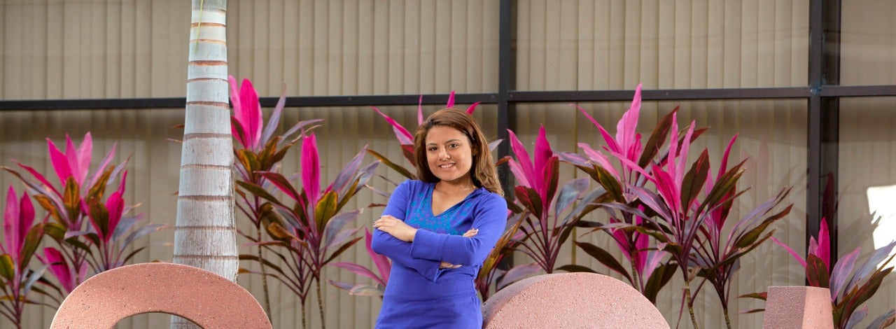 female student posing with SGA sculpture