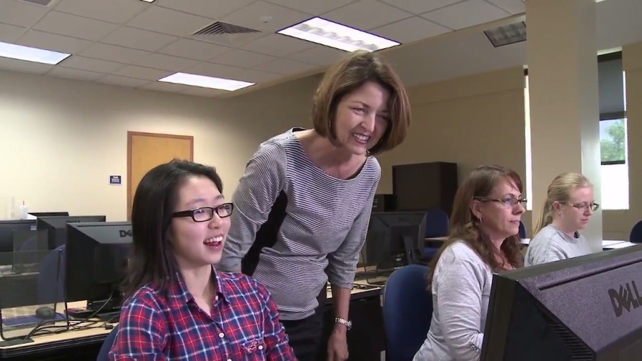 Faculty member and two students at computers