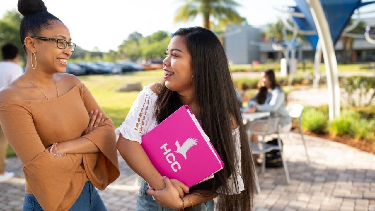 Students talking outside on campus.