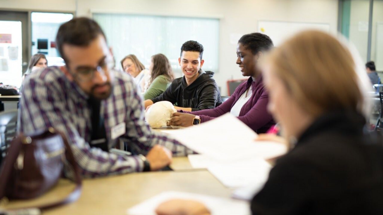 Students discussing work with their professor. 