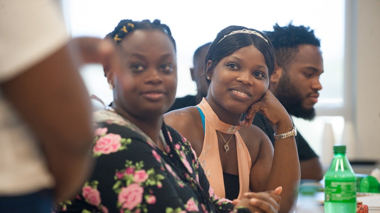 group of African American students attentively listening to a presentation