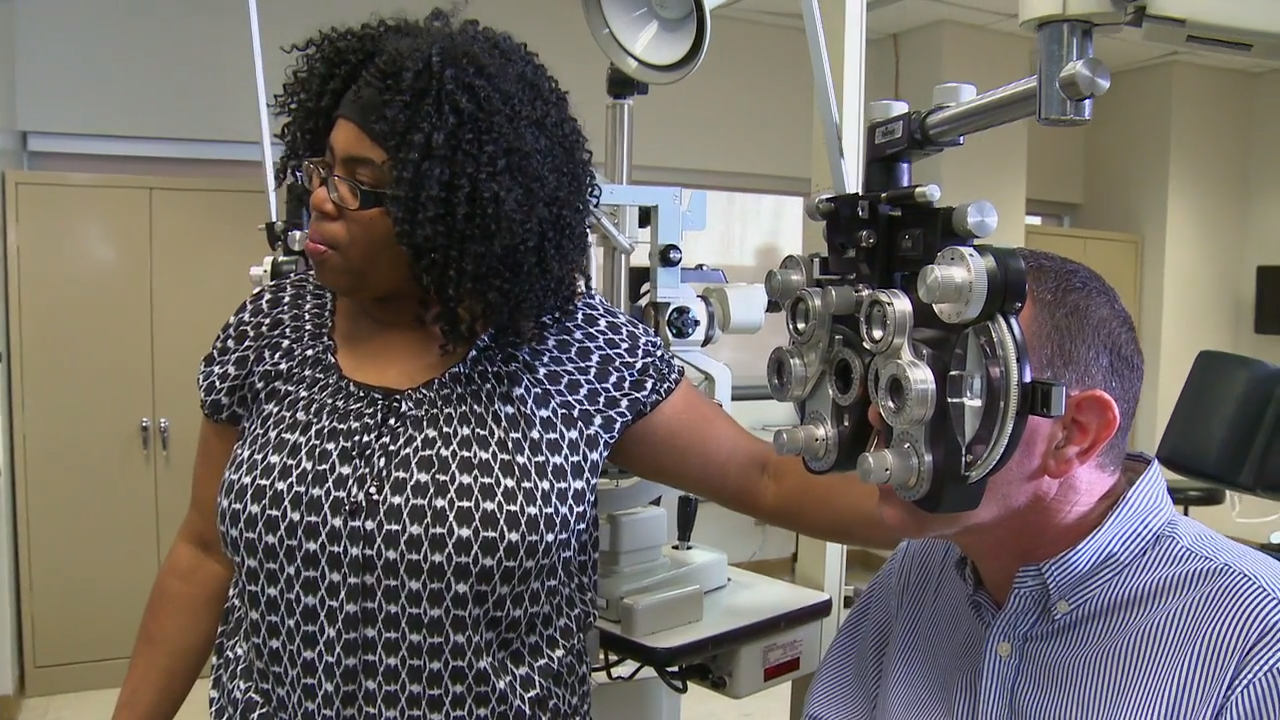 Opticianry student administering an eye exam