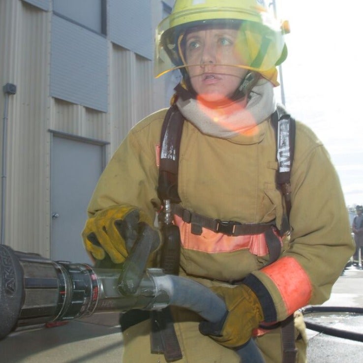 Fire fighter holding fire hose