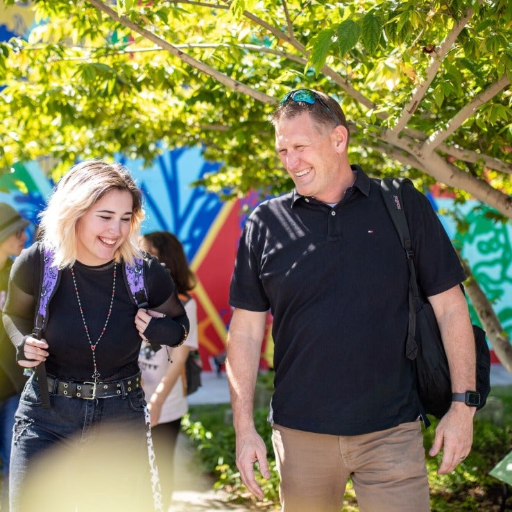 A student and faculty walking in the Ybor City Campus NEST site.